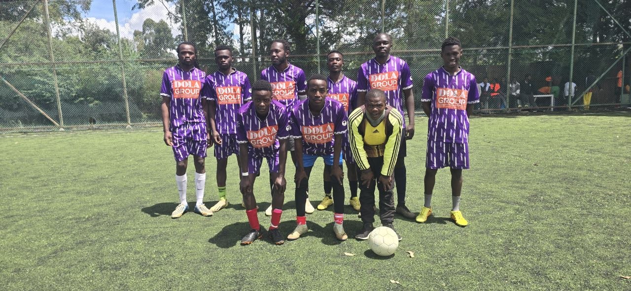 Team posing in purple Dola Group sponsored jerseys